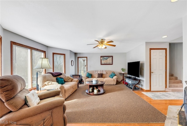 living room with light hardwood / wood-style floors and ceiling fan