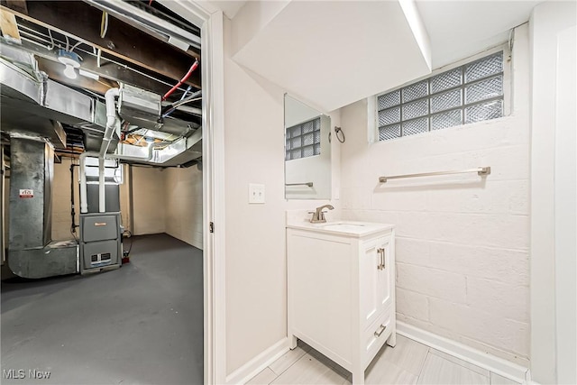 interior space with vanity, heating unit, and concrete floors