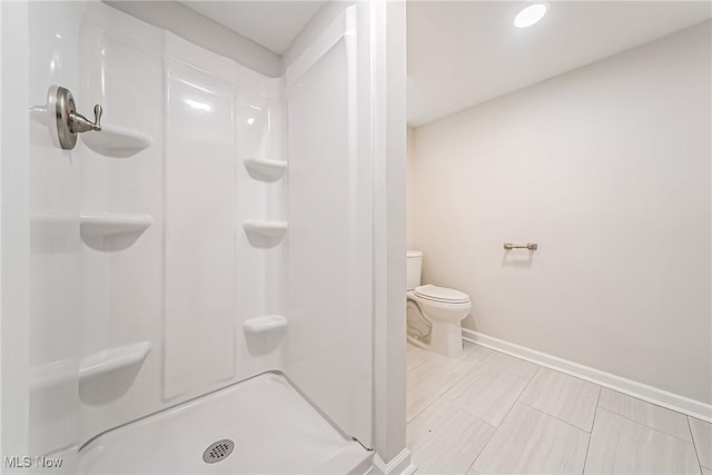 bathroom featuring toilet and a shower