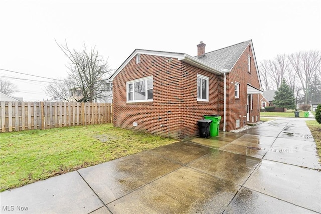 view of property exterior with a yard