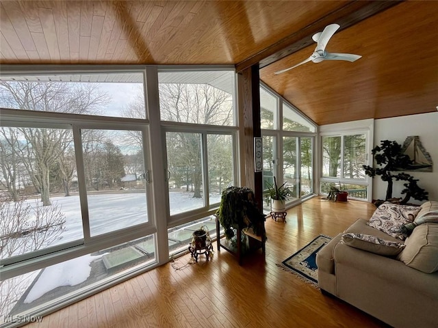 sunroom with wood ceiling, plenty of natural light, and vaulted ceiling