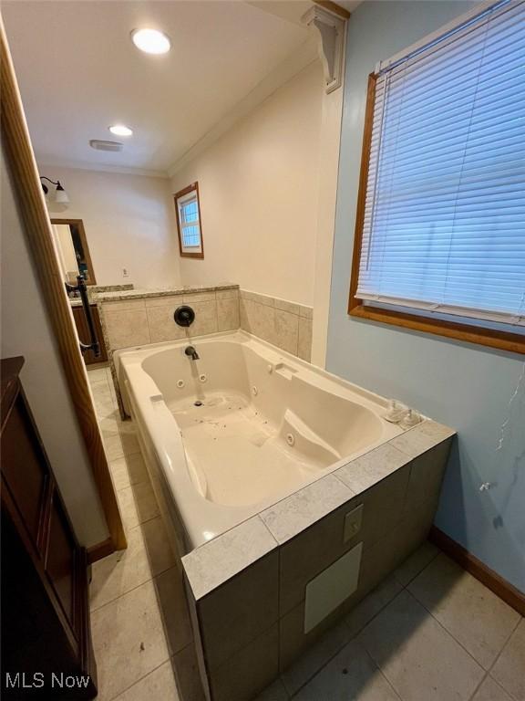 bathroom featuring tile patterned flooring and tiled tub