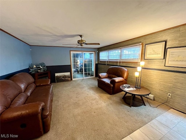 living room with ornamental molding, light carpet, and ceiling fan