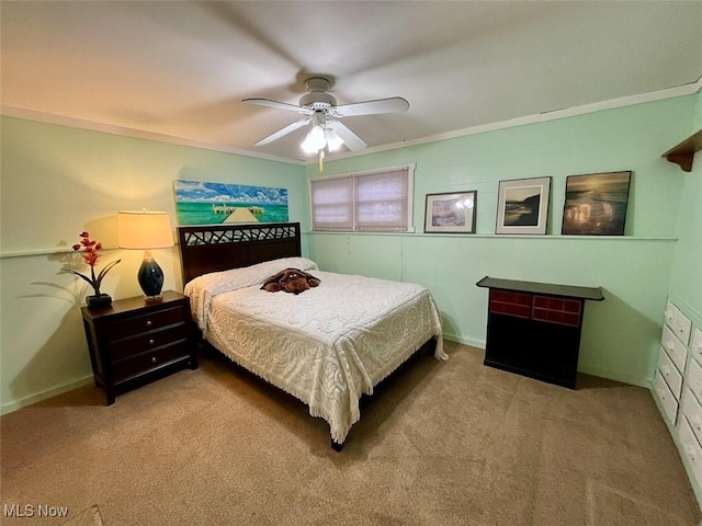 bedroom with ceiling fan, light colored carpet, and ornamental molding