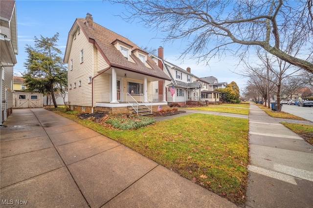 view of front of home with a front yard and a porch