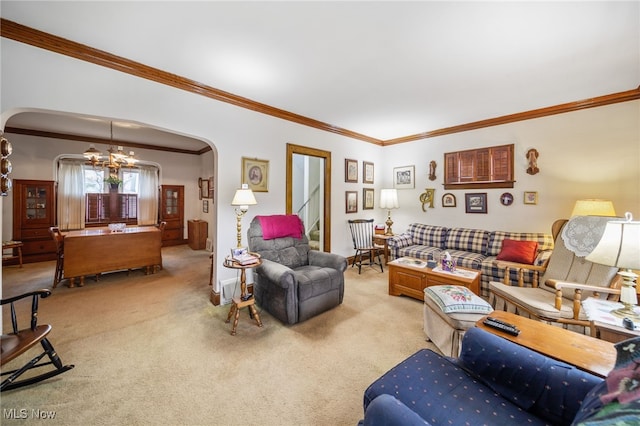 living room with ornamental molding, carpet, and a notable chandelier