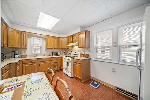 kitchen with sink, a drop ceiling, and gas range gas stove