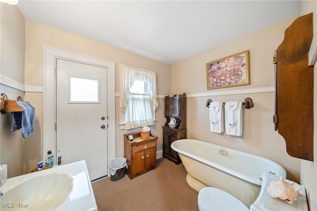 bathroom featuring sink, toilet, and a bathing tub