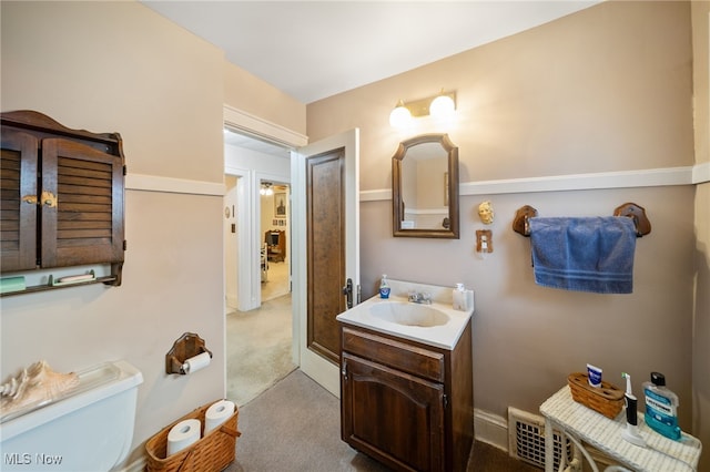 bathroom featuring vanity and toilet