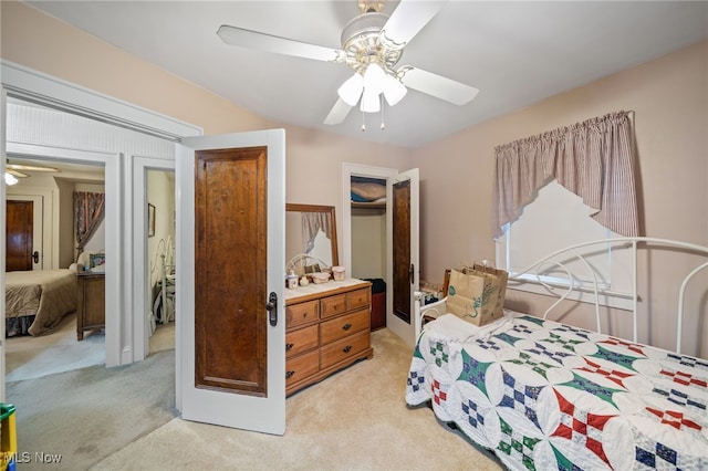 bedroom with light carpet, ceiling fan, and a closet