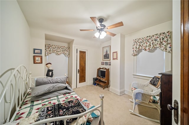 bedroom featuring light carpet and ceiling fan