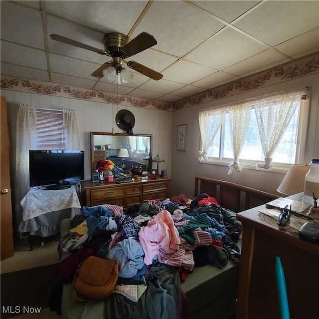 bedroom featuring ceiling fan and a drop ceiling