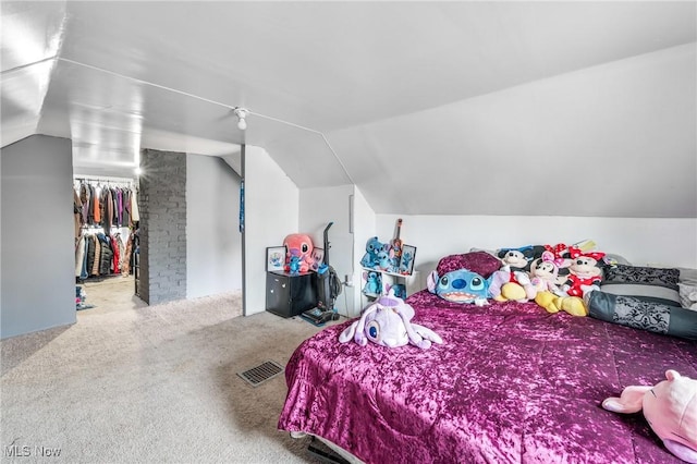 bedroom featuring lofted ceiling and carpet floors