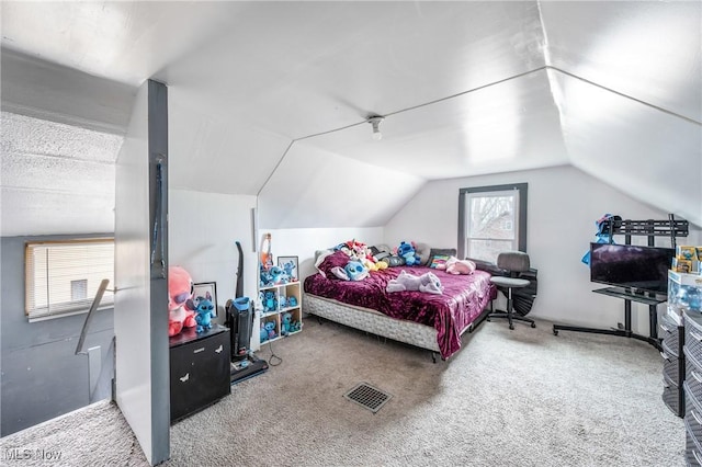 carpeted bedroom with vaulted ceiling