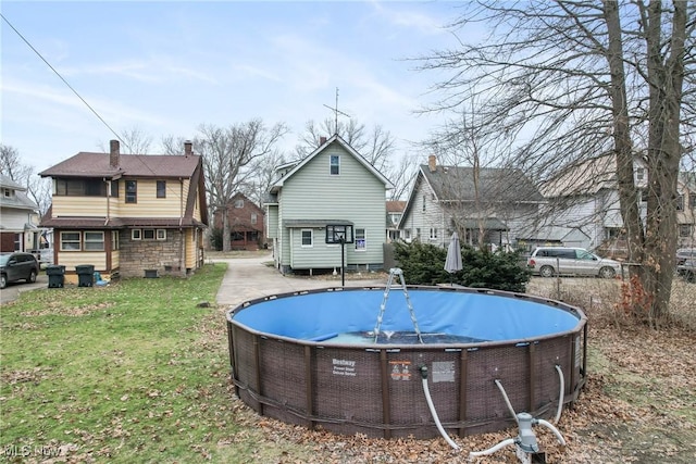 view of swimming pool with a lawn