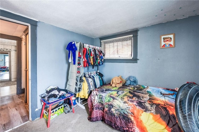 bedroom featuring carpet floors and a textured ceiling