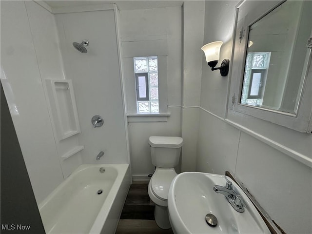 full bathroom featuring sink, shower / bathtub combination, and toilet