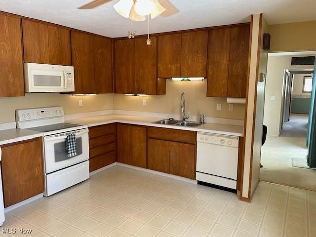 kitchen with sink, white appliances, and ceiling fan