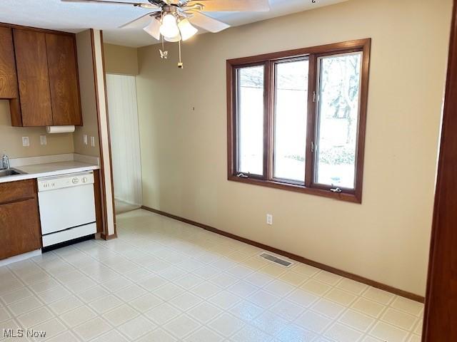 kitchen featuring ceiling fan, dishwasher, and sink