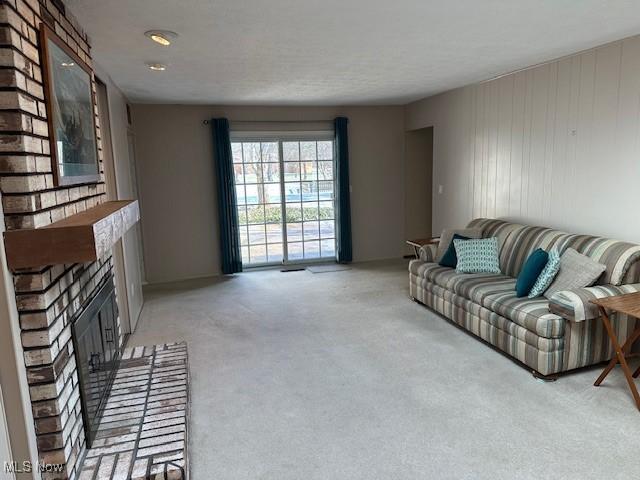 living room with light carpet and a fireplace