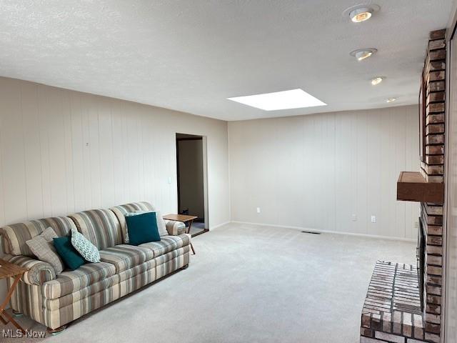 living room with carpet flooring and a skylight