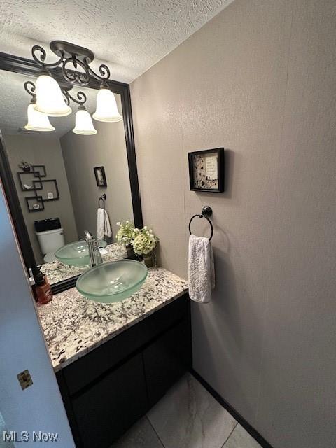 bathroom featuring vanity and a textured ceiling