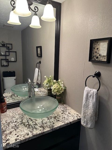 bathroom featuring vanity and toilet