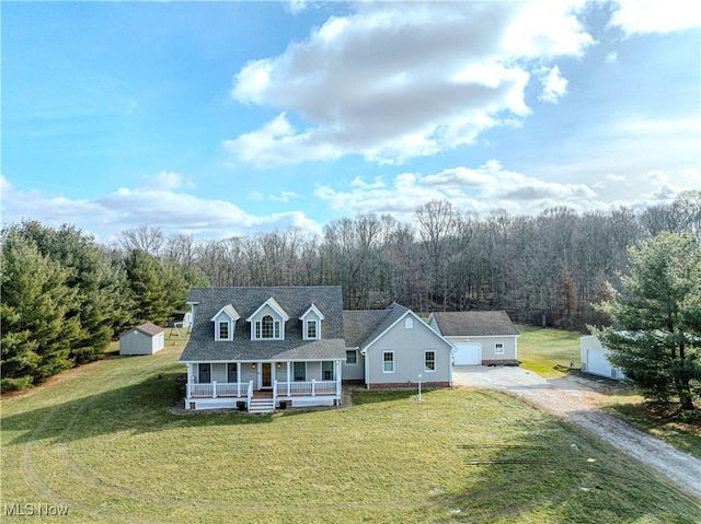 view of front facade featuring a front yard, a storage unit, and covered porch