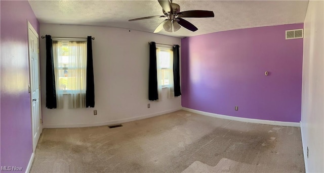 130 Rauch Dr, Marietta, OH 45750 - carpeted empty room featuring ceiling fan, plenty of natural light, and a textured ceiling