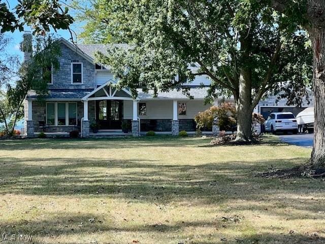 view of front of house featuring a front yard and stone siding