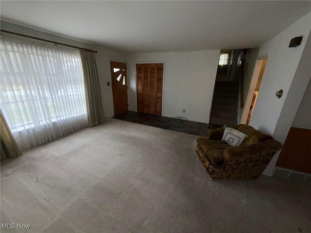 unfurnished living room featuring carpet flooring