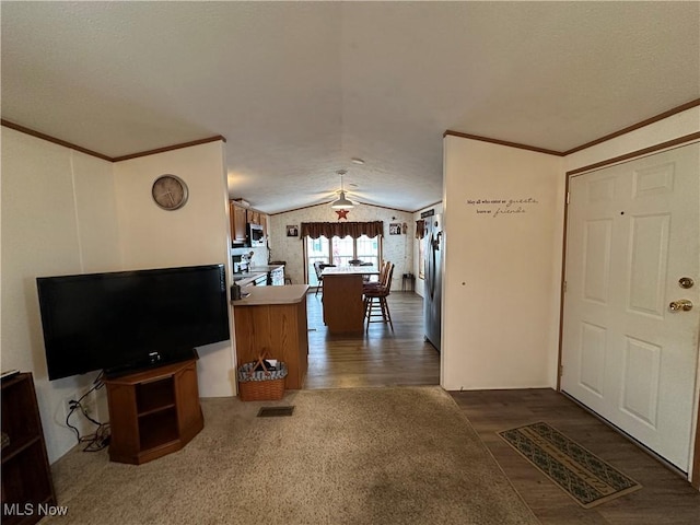 living room featuring crown molding, vaulted ceiling, and dark wood-type flooring