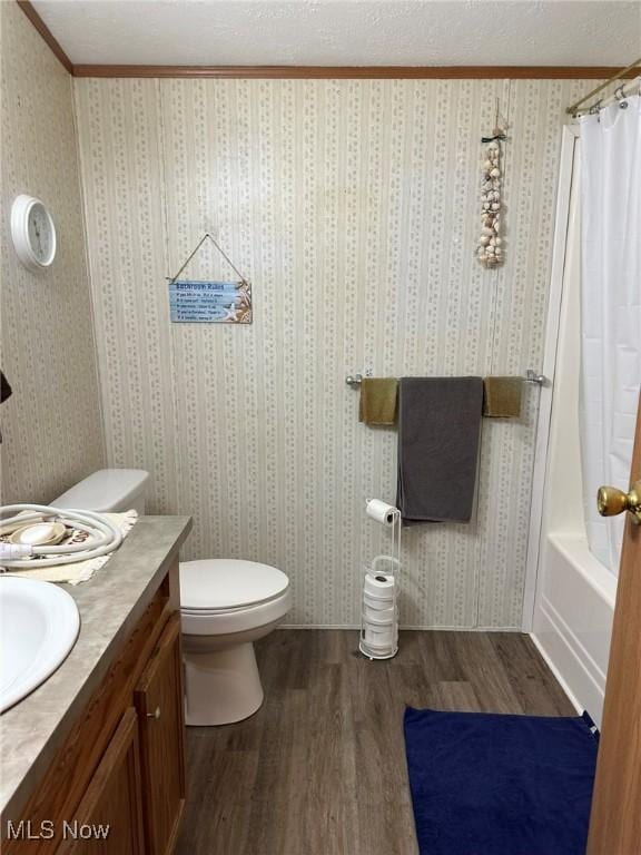 full bathroom featuring toilet, crown molding, a textured ceiling, vanity, and hardwood / wood-style floors