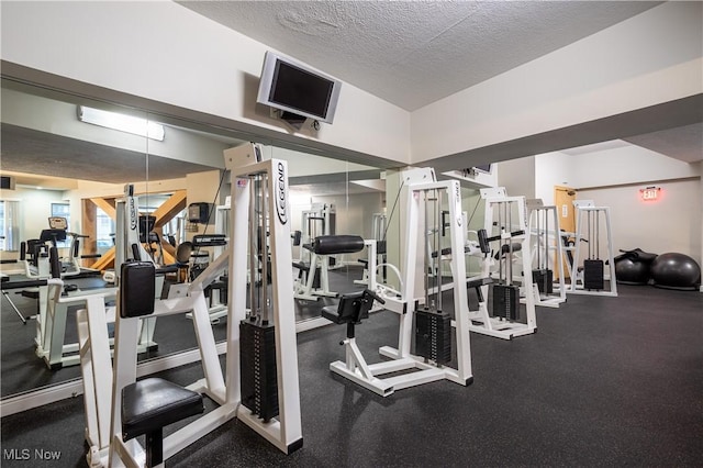 exercise room with a textured ceiling