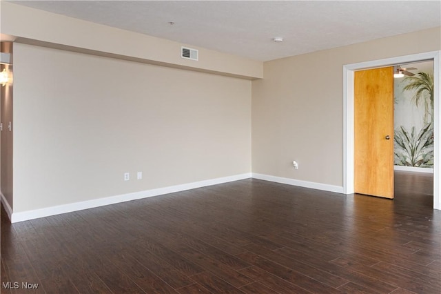 empty room with dark hardwood / wood-style floors