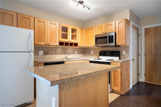 kitchen with sink, light stone counters, light brown cabinets, a kitchen island, and white appliances