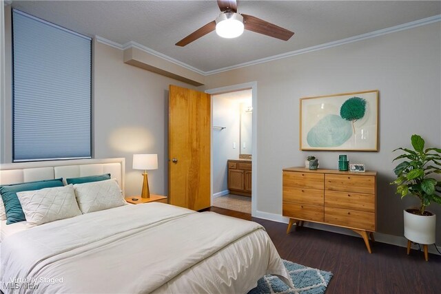 bedroom featuring dark wood-style flooring, ceiling fan, crown molding, baseboards, and ensuite bathroom