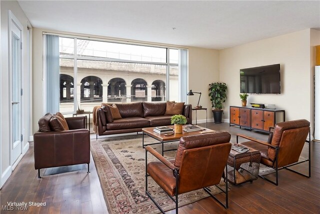 living area featuring hardwood / wood-style floors and baseboards