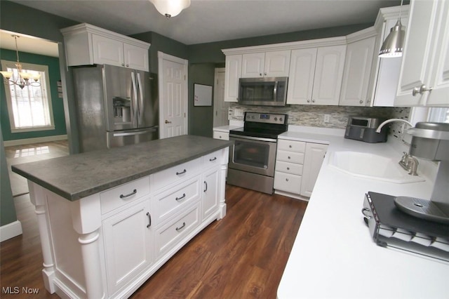 kitchen featuring appliances with stainless steel finishes, sink, and white cabinets