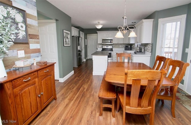 dining room with hardwood / wood-style flooring and a chandelier