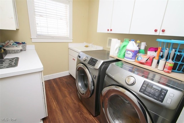 laundry area featuring cabinets, dark wood-type flooring, sink, and independent washer and dryer