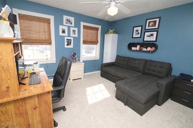 office space with light colored carpet and ceiling fan