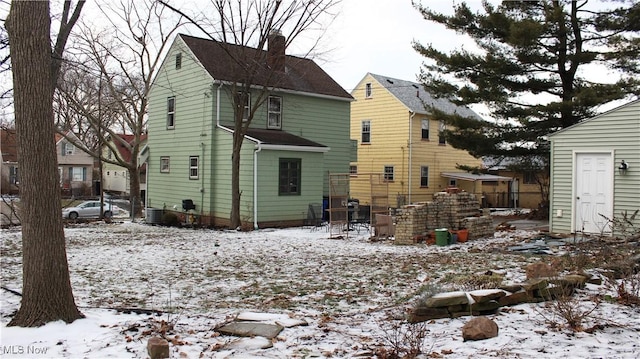 snow covered property with central air condition unit