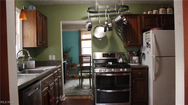 kitchen with sink, dark brown cabinets, and stainless steel appliances