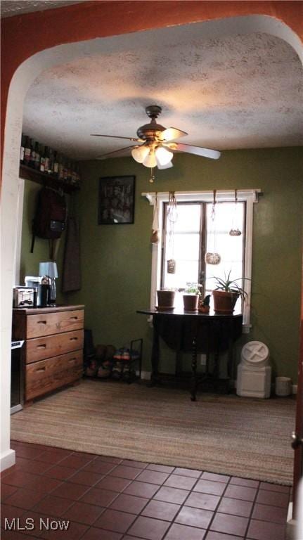 interior space featuring ceiling fan and a textured ceiling