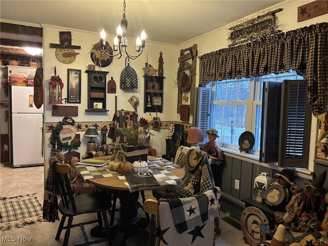 dining space featuring ornamental molding and a chandelier