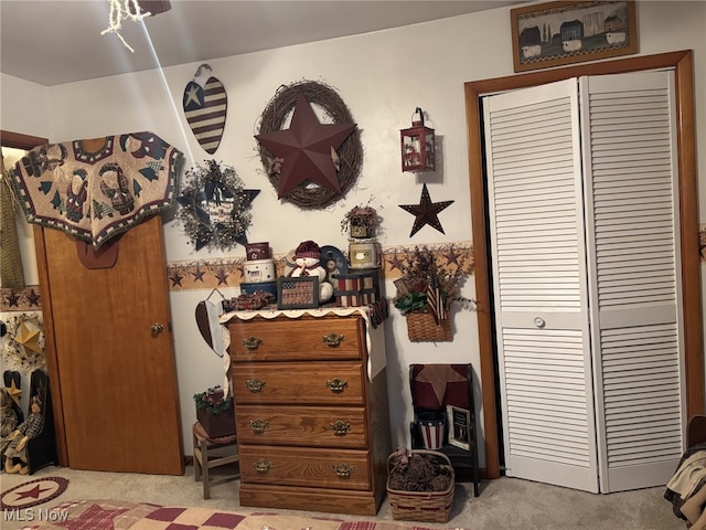 bedroom featuring light colored carpet and a closet