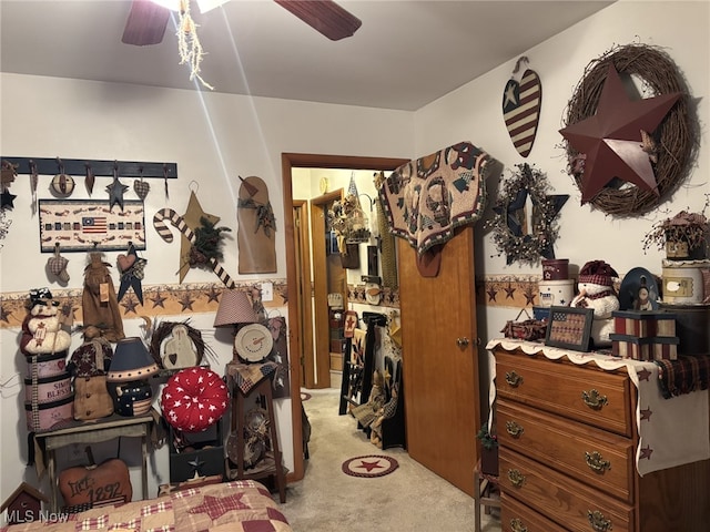 bedroom featuring light colored carpet and ceiling fan