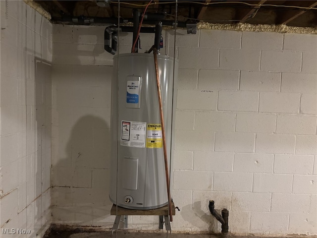 utility room featuring water heater