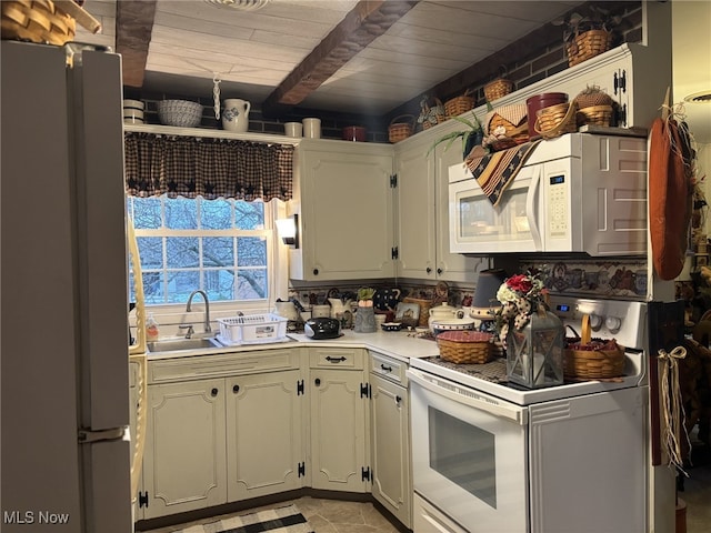 kitchen with beam ceiling, sink, white appliances, and wooden ceiling